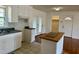 Bright kitchen featuring white cabinets, a butcher block island, and stainless steel appliances at 1031 Jackson Royster Rd, Henderson, NC 27537