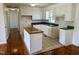 Bright kitchen featuring white cabinets, an island, and stainless steel appliances at 1031 Jackson Royster Rd, Henderson, NC 27537