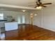 Open-concept living space with hardwood floors, ceiling fan, and a view into the kitchen and dining area at 1031 Jackson Royster Rd, Henderson, NC 27537