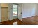 Bright living room featuring hardwood floors, white walls, and an open doorway to the outside at 1031 Jackson Royster Rd, Henderson, NC 27537