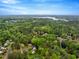 Stunning aerial view of a lush, green neighborhood with mature trees and glimpses of a tranquil lake in the distance at 104 Dilworth Ct, Cary, NC 27513