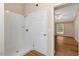 Bathroom with a white shower, complemented by a bright bedroom featuring a window at 104 Dilworth Ct, Cary, NC 27513