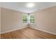Bedroom with a window offering natural light and wood-style floors at 104 Dilworth Ct, Cary, NC 27513