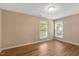 Bedroom featuring two windows for ample sunlight and wood-style flooring at 104 Dilworth Ct, Cary, NC 27513