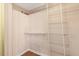 Walk-in closet with custom shelving and wooden floors offers ample storage space at 104 Dilworth Ct, Cary, NC 27513