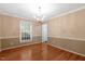 Elegant dining room with hardwood floors, crown molding, and a stylish chandelier at 104 Dilworth Ct, Cary, NC 27513