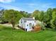 Rear view of a home showcasing a deck and a lush green lawn at 104 Dilworth Ct, Cary, NC 27513