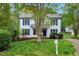 Landscaped front yard with a charming two-story home featuring blue shutters at 104 Dilworth Ct, Cary, NC 27513