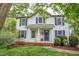 Charming two-story home featuring a welcoming front porch and blue shutters at 104 Dilworth Ct, Cary, NC 27513