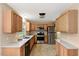 Well-lit kitchen with stainless steel appliances and wooden cabinets at 104 Dilworth Ct, Cary, NC 27513