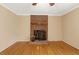Spacious living room featuring a classic brick fireplace and hardwood flooring at 104 Dilworth Ct, Cary, NC 27513