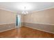 Spacious living room with hardwood floors and elegant chandelier at 104 Dilworth Ct, Cary, NC 27513