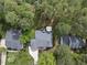 Aerial view of the property, showcasing the home's location among mature trees, driveway, and backyard deck at 109 Deer Valley Dr, Cary, NC 27519