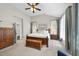 Bright bedroom featuring a bed, wooden chest, and neutral decor with many windows for ample natural light at 109 Deer Valley Dr, Cary, NC 27519