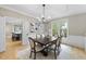 Bright dining room with modern chandelier, wainscoting, and large windows at 109 Deer Valley Dr, Cary, NC 27519