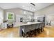 Open kitchen featuring a granite island with seating, desk area, and stainless appliances at 109 Deer Valley Dr, Cary, NC 27519