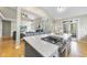 Kitchen view featuring granite island with seating, stainless cooktop, and open floor plan at 109 Deer Valley Dr, Cary, NC 27519