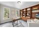 Home office featuring custom wood built-ins, desk, and large windows at 109 Deer Valley Dr, Cary, NC 27519