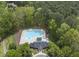 Aerial view of the community pool, surrounded by lush trees and complete with lounge chairs at 109 Deer Valley Dr, Cary, NC 27519