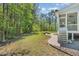 Spacious backyard with green lawn, brick patio, fire pit, and wooded perimeter at 1101 Sky Wave Trl, Raleigh, NC 27603