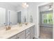 Bathroom featuring double sink vanity, grey cabinets and door to a bedroom at 1101 Sky Wave Trl, Raleigh, NC 27603