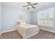 Bedroom with white wood bed, neutral carpet, and plantation shutters at 1101 Sky Wave Trl, Raleigh, NC 27603