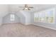 Bright bedroom with large windows, shutters, ceiling fan, and neutral carpet at 1101 Sky Wave Trl, Raleigh, NC 27603