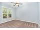 Bedroom with a large window, carpet, and a ceiling fan at 1101 Sky Wave Trl, Raleigh, NC 27603