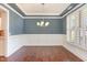 Elegant dining room with wainscoting and plantation shutters at 1101 Sky Wave Trl, Raleigh, NC 27603