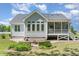 Rear exterior view of a home with a patio, fire pit, and screened-in porch at 1101 Sky Wave Trl, Raleigh, NC 27603