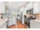 Open kitchen with stainless appliances and breakfast bar seating at 1101 Sky Wave Trl, Raleigh, NC 27603
