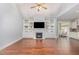 Bright living room with built-in shelves and a fireplace, open to the kitchen at 1101 Sky Wave Trl, Raleigh, NC 27603