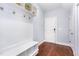 Mudroom with coat hooks, bench, storage shelves, and hardwood floors at 1101 Sky Wave Trl, Raleigh, NC 27603