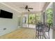 Screened-in porch with wood floors, ceiling fan, and outdoor dining set at 1101 Sky Wave Trl, Raleigh, NC 27603