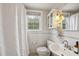 Bright bathroom featuring a shower with curtain, toilet, and a sink with a vanity at 1105 Englewood Ave, Durham, NC 27701