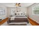Bright bedroom with a large bed, two bedside tables, and natural light from the windows at 1105 Englewood Ave, Durham, NC 27701