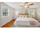 Bright bedroom featuring hardwood floors, a ceiling fan, and an abundance of natural light at 1105 Englewood Ave, Durham, NC 27701