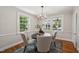 Bright dining room features natural light, a modern chandelier, and seating for four at 1105 Englewood Ave, Durham, NC 27701