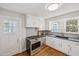 This updated kitchen is equipped with modern stainless steel appliances and a gas range at 1105 Englewood Ave, Durham, NC 27701