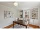Bright home office with custom built-ins, a large desk, and ample natural light from two windows at 1105 Englewood Ave, Durham, NC 27701