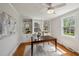 Bright home office with custom built-ins, a large desk, and ample natural light from two windows at 1105 Englewood Ave, Durham, NC 27701