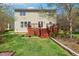 Multi-level deck, beautiful lawn, and backyard landscaping create an inviting outdoor space at 1127 Woodlands Creek Way, Apex, NC 27502