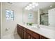 Bathroom boasts double sink vanity and a glass door shower at 1127 Woodlands Creek Way, Apex, NC 27502