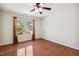 Sunlit bedroom with beautiful hardwood flooring and ceiling fan at 1127 Woodlands Creek Way, Apex, NC 27502