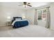 Bright bedroom features large window, ceiling fan, and neutral carpeting at 1127 Woodlands Creek Way, Apex, NC 27502