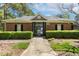 Community pool entrance framed by manicured hedges and a secure gate at 1127 Woodlands Creek Way, Apex, NC 27502