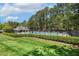 Community pool surrounded by mature trees and ample seating for residents at 1127 Woodlands Creek Way, Apex, NC 27502