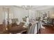 Open concept with dining room table near the foyer and a living room with neutral furniture at 1127 Woodlands Creek Way, Apex, NC 27502