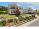 Beautifully landscaped front yard with flower beds leading up to a charming two-story home at 1127 Woodlands Creek Way, Apex, NC 27502