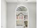 Bright foyer featuring a grand arched window and a modern decorative chandelier at 1127 Woodlands Creek Way, Apex, NC 27502